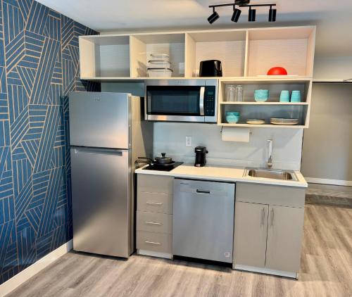 a kitchen with a refrigerator and a sink at MainStay Suites Columbus North - Worthington in Columbus