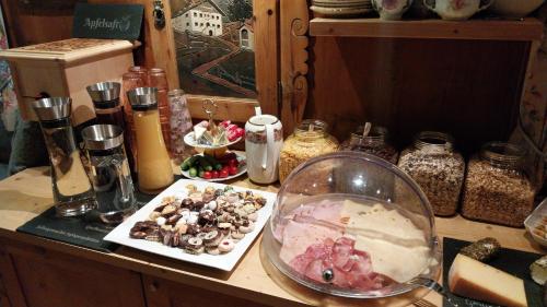 a counter top with a bowl of food and other items at Thalerhof in Roppen