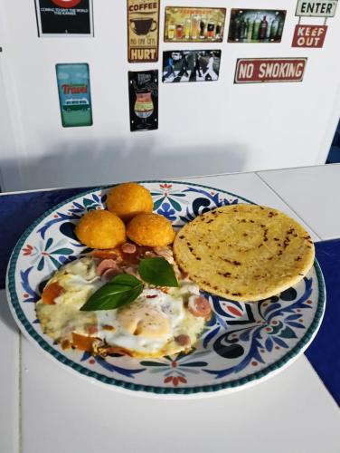 a plate of food with eggs and bread on a counter at Casa Skyros in Arboletes