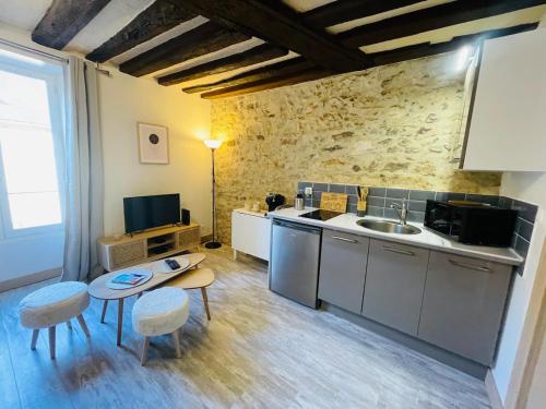 a kitchen with a sink and a table and chairs at Le Studio du Vieux-Mans - 2 guests - Wifi in Le Mans