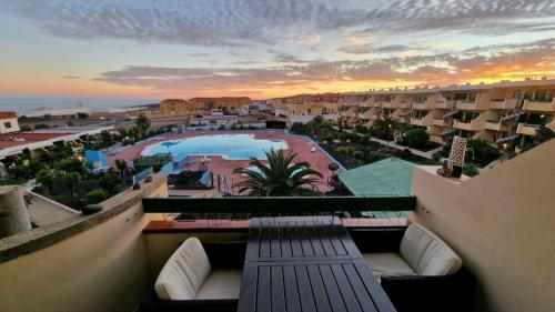 a view of a pool from the balcony of a resort at Wind House in Costa de Antigua