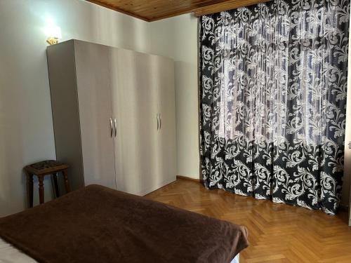 a room with a black and white shower curtain at Hotel Cattaleya in Batumi