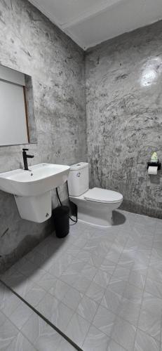 a bathroom with a sink and a toilet at Lanta Mango Beach Houses in Phra Ae beach