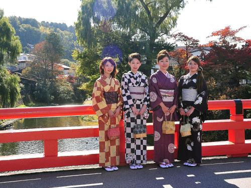 
a family posing for a picture on a bridge at Spa Hotel Alpina Hida Takayama in Takayama
