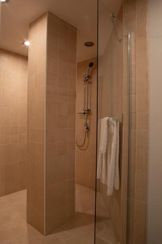 a bathroom with a shower with a glass door at Motel Soignè in Mapello