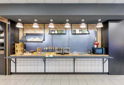 a counter in a restaurant with a blue wall at B&B HOTEL Lille Centre Grand Palais in Lille