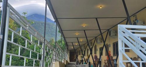 a building with a large window with a mountain view at Holi Homestay Trawas in Trawas