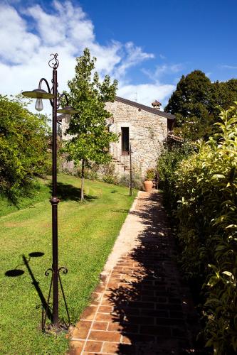 a street light next to a brick path at Mulino di Casa Sforza Suites and Spa in Basilicanova