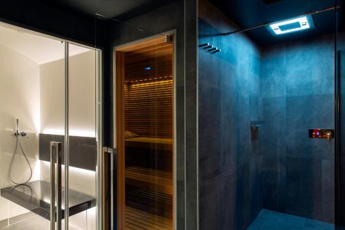 a bathroom with a shower with a glass door at Mulino di Casa Sforza Suites and Spa in Basilicanova