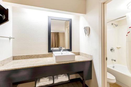 a bathroom with a sink and a toilet at Red Roof Inn PLUS+ Mt Pleasant - Patriots Point in Charleston