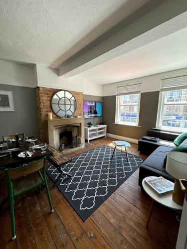 a living room with a couch and a fireplace at Canford Cliffs Apartment in Poole