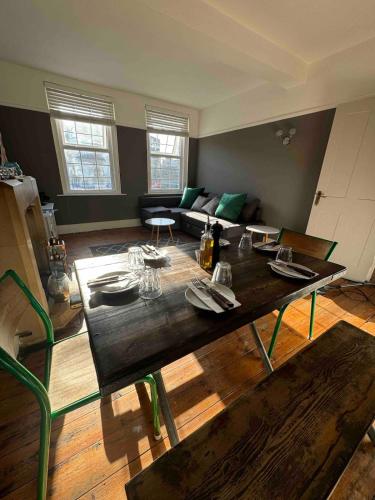 a living room with a table and a couch at Canford Cliffs Apartment in Poole