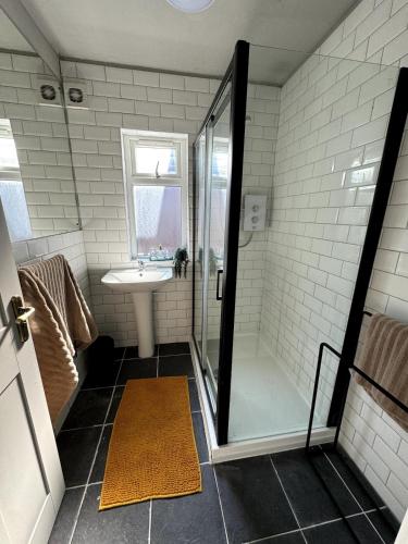 a bathroom with a shower and a sink at Canford Cliffs Apartment in Poole