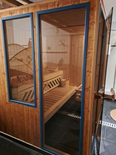 a glass door of a sauna with a boat inside at Petit gîte La vigne est belle - 2 étoiles- Sud Charente in Lagarde-sur-le-Né