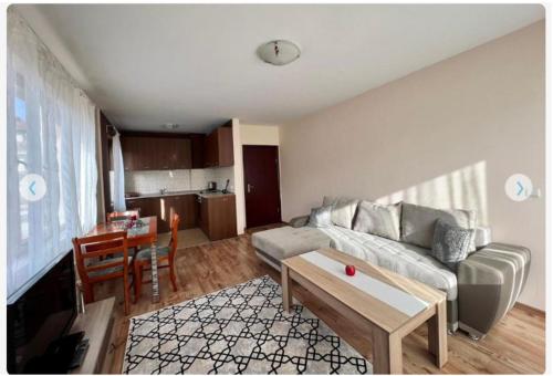 a living room with a couch and a table at Prime Apartments in Bansko