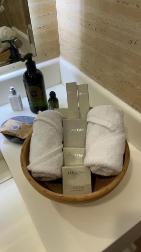 a basket of towels on a counter in a bathroom at Al Malfa Resort & Hotel in Unayzah
