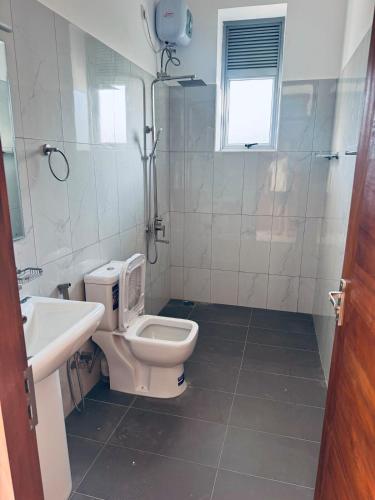 a bathroom with a toilet and a sink and a shower at URBAN 17 - Experience comfort & convenience in Moratuwa