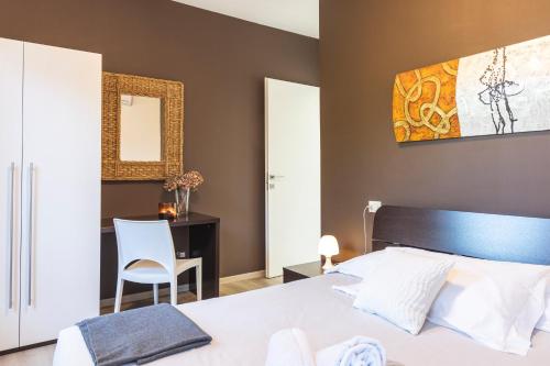 a bedroom with a bed and a desk and a chair at Il Giardino Di Lory in Vercana