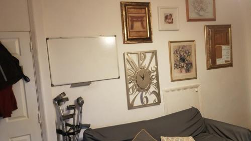 a room with a white board and a clock on the wall at 42 Churchbury Rd, Room 3 in Eltham
