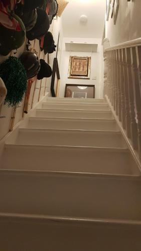 a stairway with white steps and a ceiling at 42 Churchbury Rd, Room 3 in Eltham