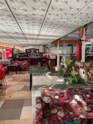 a lobby of a store with tables and chairs at Au soleil couchant in Mirleft