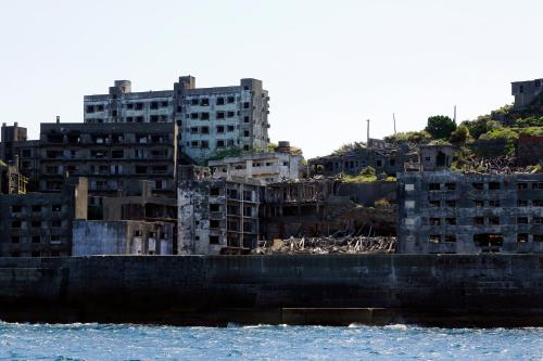 a group of buildings on a hill next to the water at Hotel Monterey Nagasaki in Nagasaki