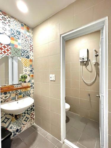 a bathroom with a shower and a sink and a toilet at Sun Home - Gần Cột Cờ Bãi Sau - Free Bida - Karaoke in Vung Tau