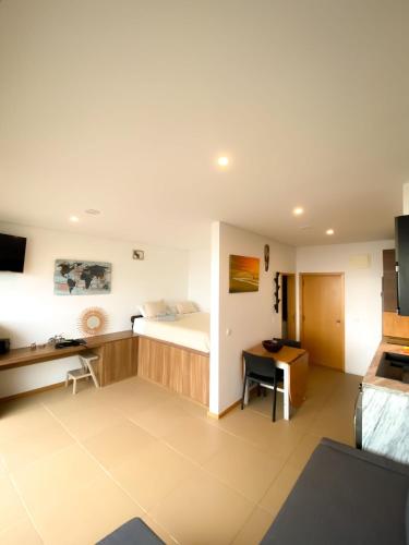 a hotel room with a bed and a desk at MARESIA APART T0 - Praia do Furadouro in Ovar