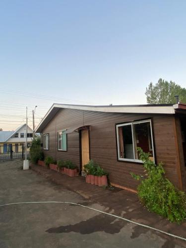 a small house with a parking lot in front of it at Cabaña AL-YEEN in El Manzano
