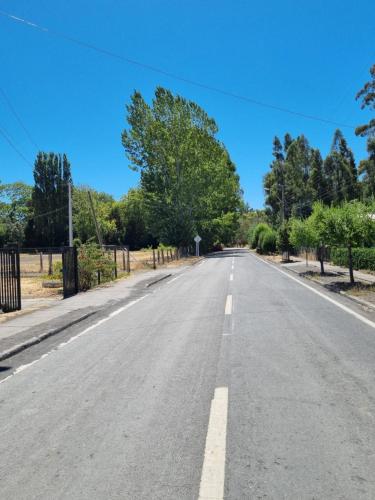 an empty road with trees on either side at Cabaña AL-YEEN in El Manzano