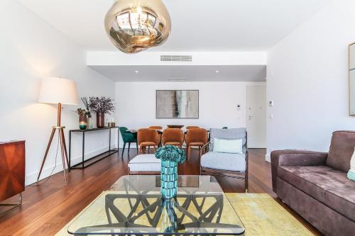a living room with a couch and a table at Alcantara Lovely With Balcony 2 Bdr Apt with AC in Lisbon