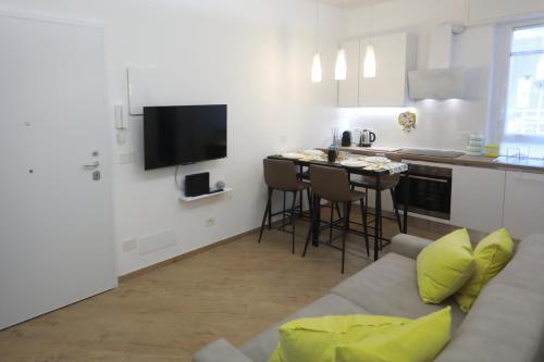 a living room with a couch and a kitchen at Il Girasole in Arenzano