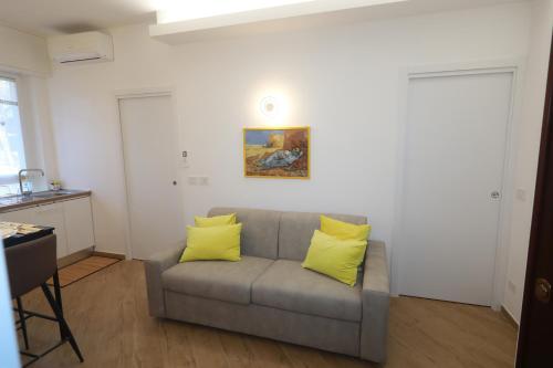 a living room with a couch with two yellow pillows at Il Girasole in Arenzano