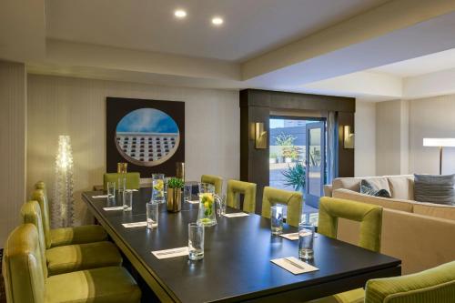 a dining room with a long table and yellow chairs at Renaissance Phoenix Downtown Hotel in Phoenix