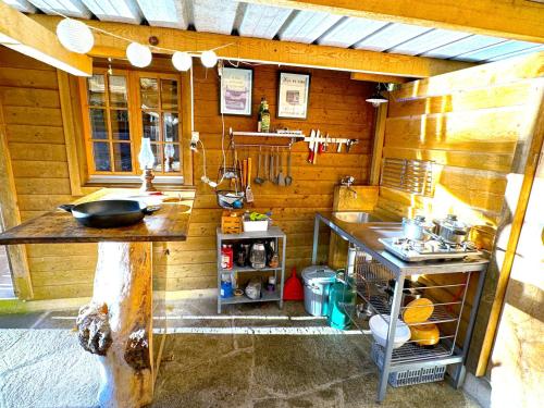 a small kitchen with a counter and a sink at SwissHut Idyllic Farm Cabin - Chalet Grabenmuhle 2 in Sigriswil