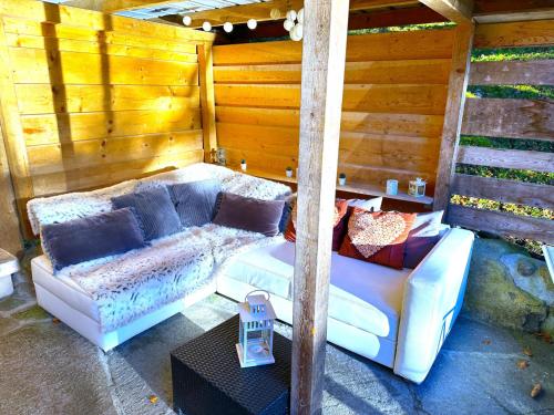 a living room with a couch and a table at SwissHut Idyllic Farm Cabin - Chalet Grabenmuhle 2 in Sigriswil