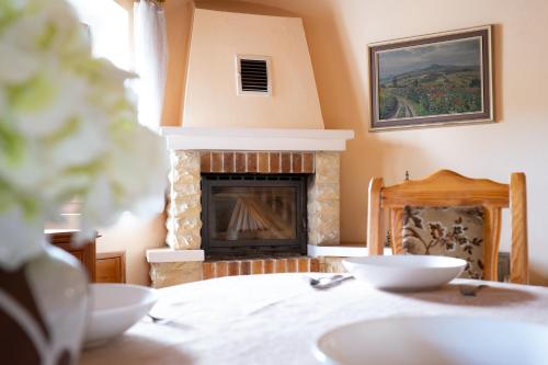 a living room with a fireplace and a table at Statek u Berků in Svatý Jan