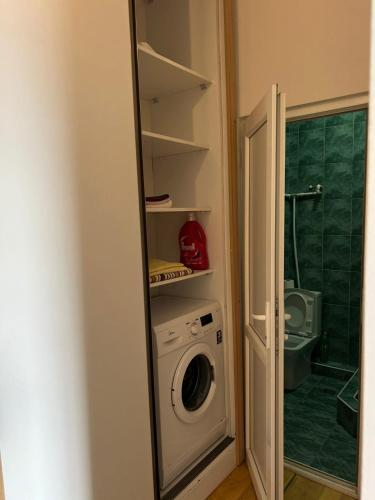 a washer and dryer in a room with a bathroom at Apartament at Gegidze street in Poti