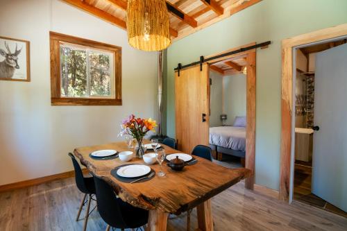 a dining room with a wooden table and chairs at Cabaña Ciervo in Puerto Varas