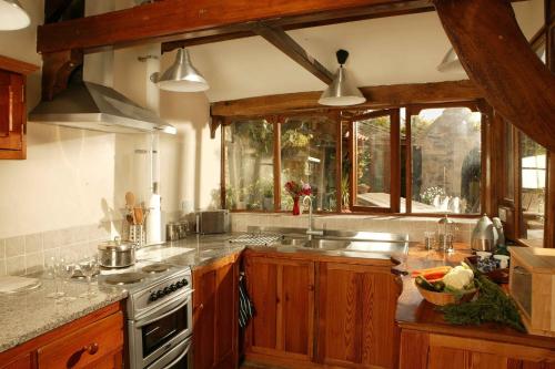 a kitchen with a sink and a stove at Spindle Cottage Holidays in Radstock