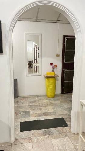 an archway in a room with a yellow vase at บ้านเพื่อน @อุทัยธานี in Ban Don Khwang