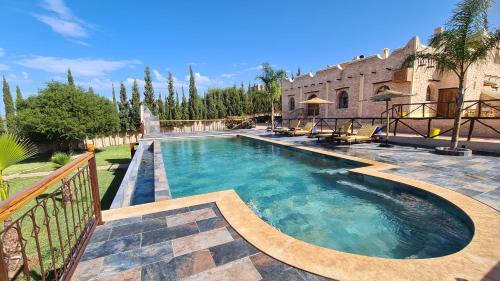 a swimming pool in front of a house at Villa AMMA in Essaouira