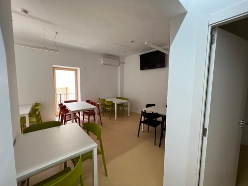 a dining room with tables and chairs and a window at Alberg Os de Balaguer in Os de Balaguer