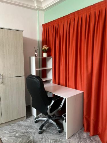an office with a desk and a red curtain at Chambres d'Hôtes Centre Ville in Dakar