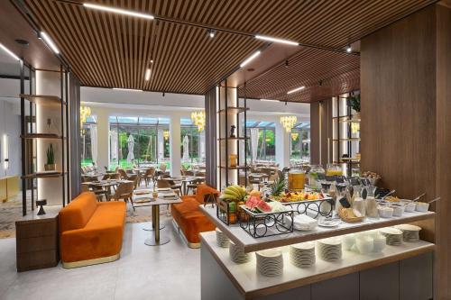 a restaurant with a buffet with food on a table at Radisson Hotel Plovdiv in Plovdiv
