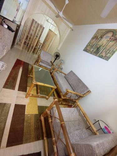 a living room with a chair and a mirror at AMAL HoME in Ouagadougou