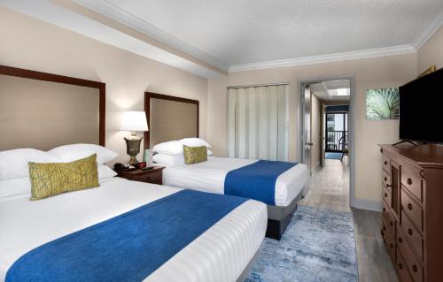 a hotel room with two beds and a flat screen tv at Sea Crest Oceanfront Resort in Myrtle Beach