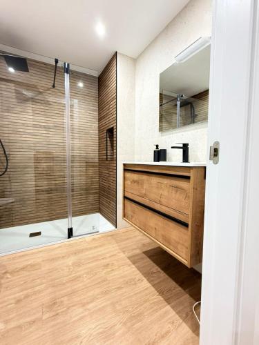 a bathroom with a sink and a shower at Reformado Centro con Terraza in Castro-Urdiales