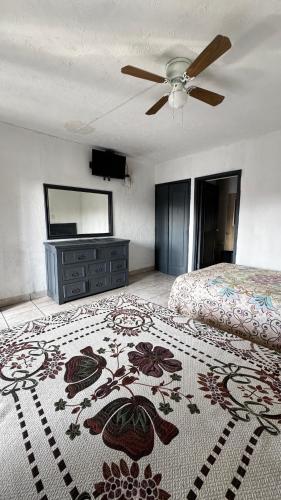 a bedroom with a bed and a ceiling fan at Hotel Nuevo Vallarta in Guadalajara