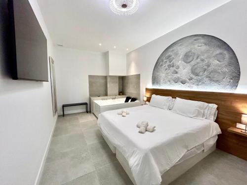a bedroom with a bed with a teddy bear on it at Valencia Getaway - Jacuzzi, Space & Comfort in Valencia